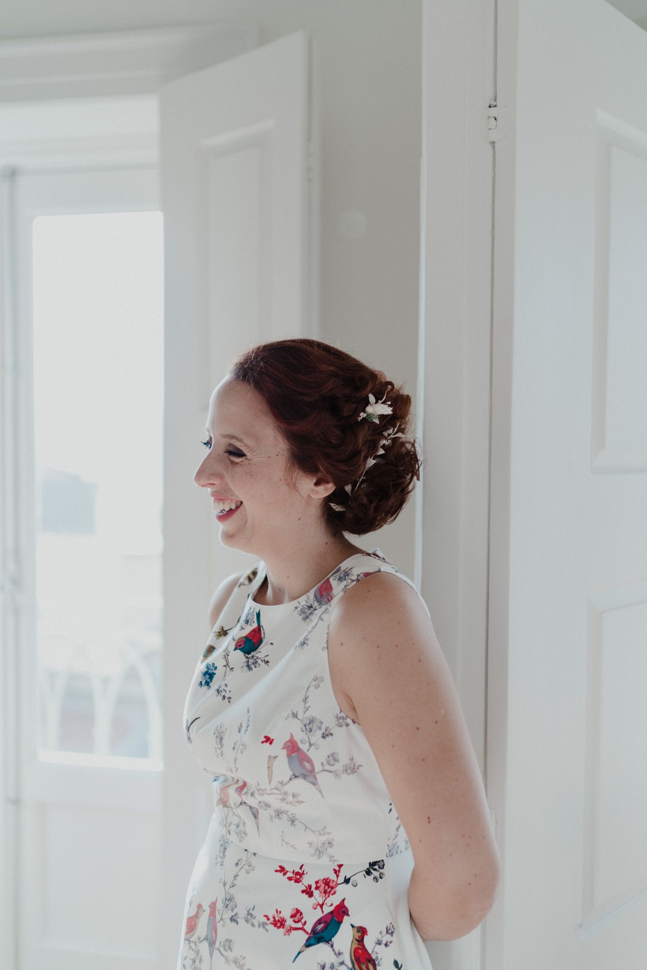 Bride standing by the window during wedding preparations in Porto