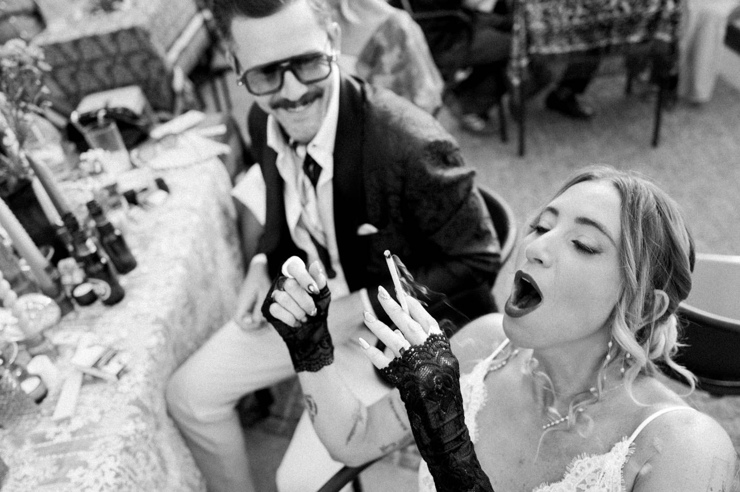 Alternative wedding photography in Porto, Portugal — candid black and white portrait of a bride smoking during her wedding at Airbnb Bridge