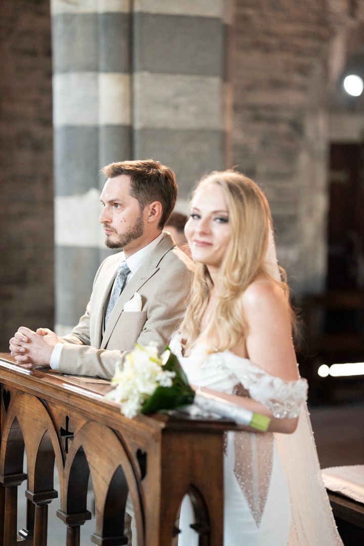 Wedding couple standing together during the church ceremony