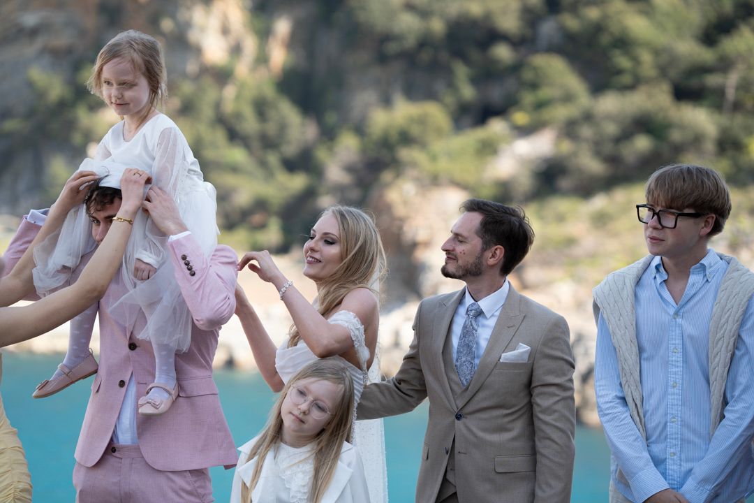 Wedding guests celebrating by the sea in Liguria
