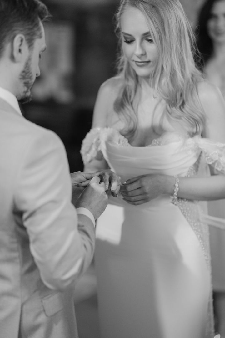 Black and white wedding ring exchange during the ceremony