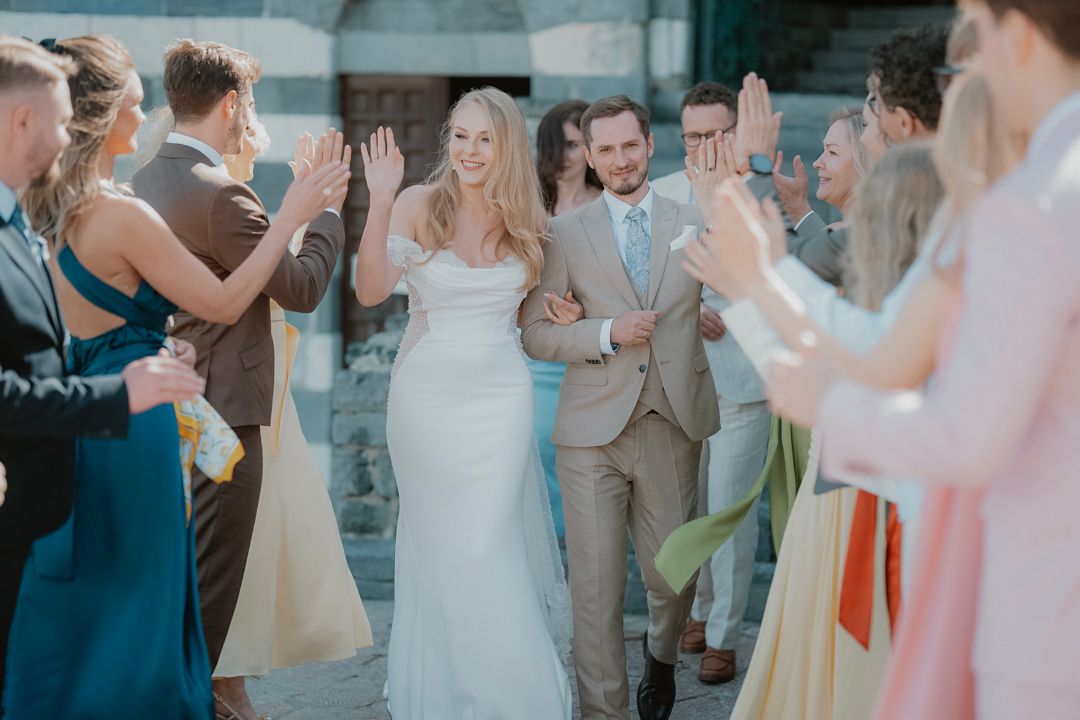 Wedding couple walking through guests at a Ligurian celebration