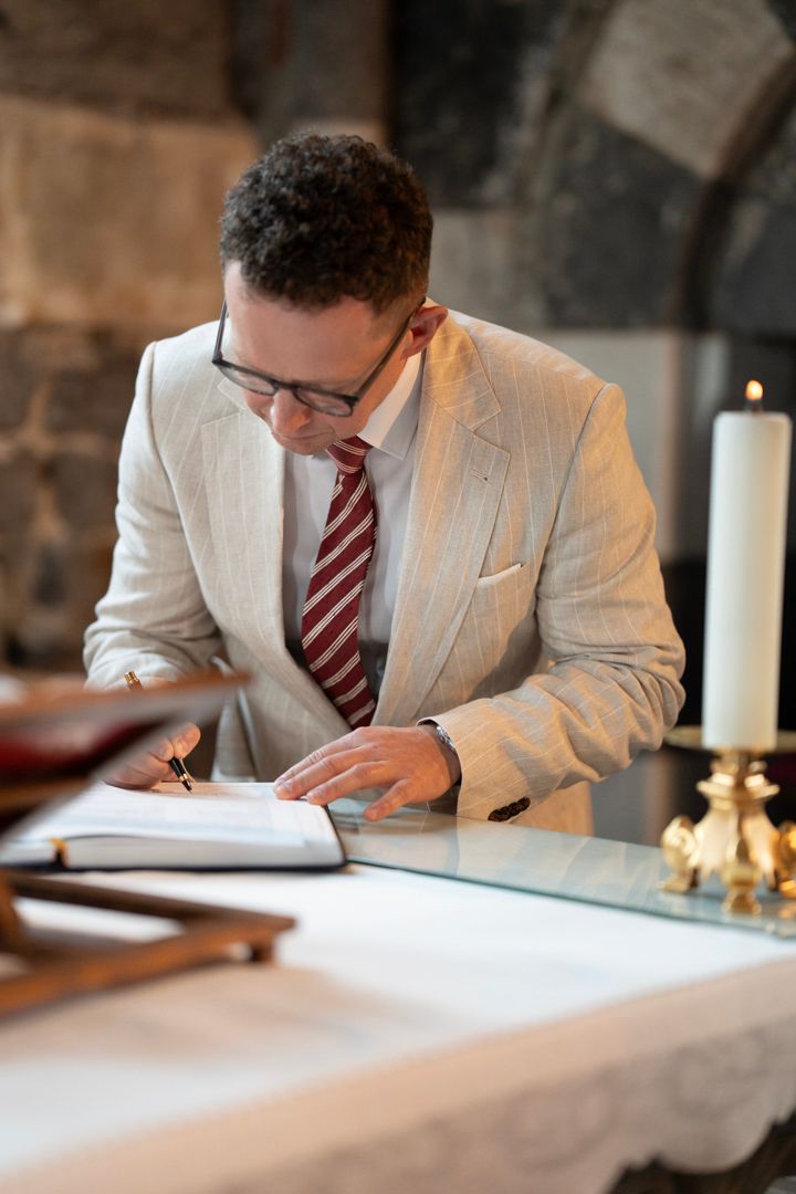 Wedding ceremony witness signing the register