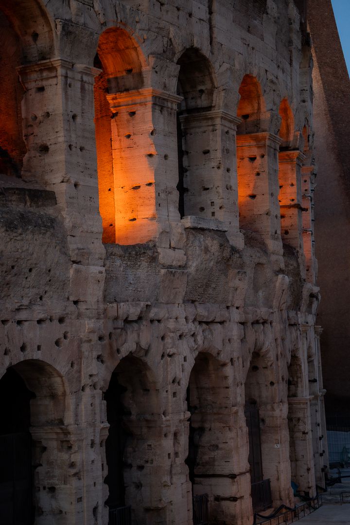 Colosseum illuminated at dusk in Rome, Italy