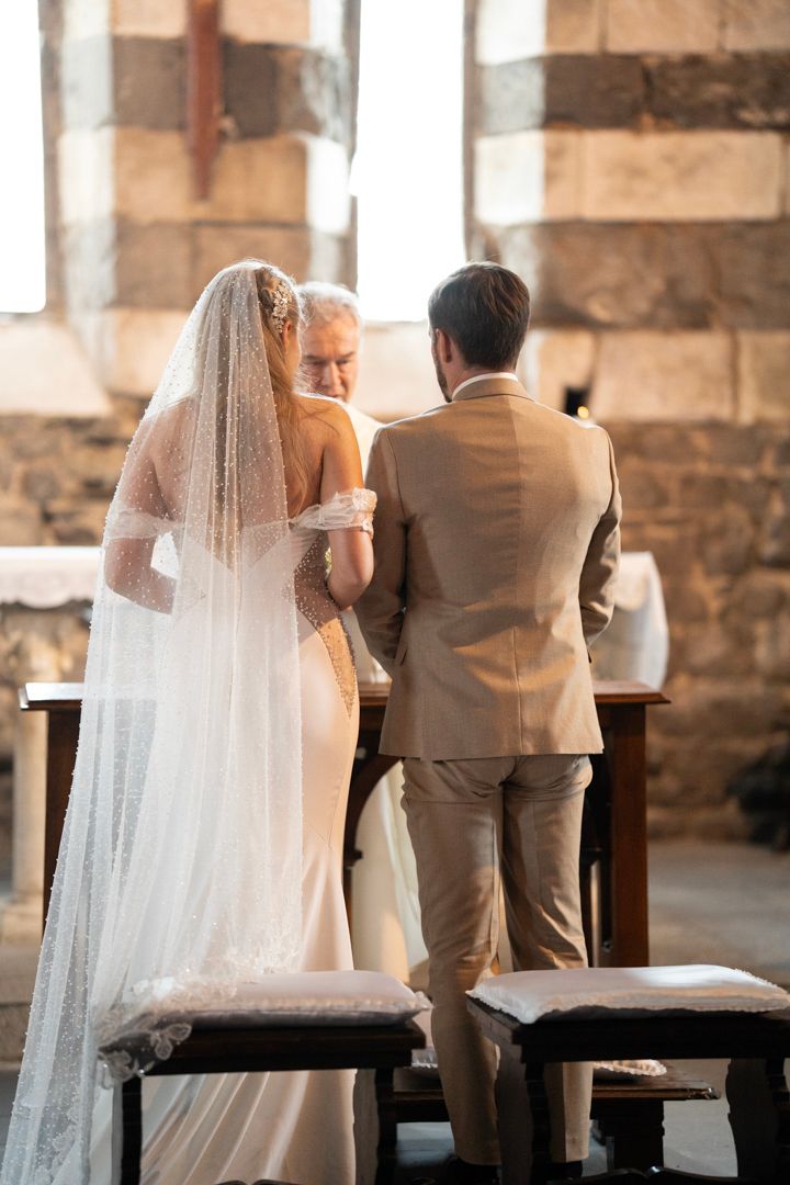 Wedding couple standing at the altar inside the church