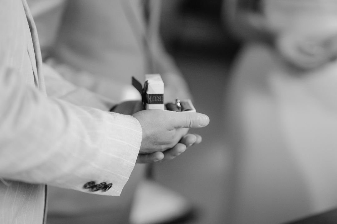 Black and white close-up of wedding rings during the ceremony