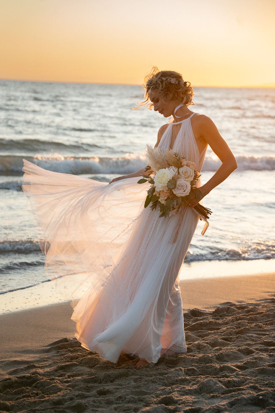 Wedding portrait on the beach at sunset in Tuscany, Italy