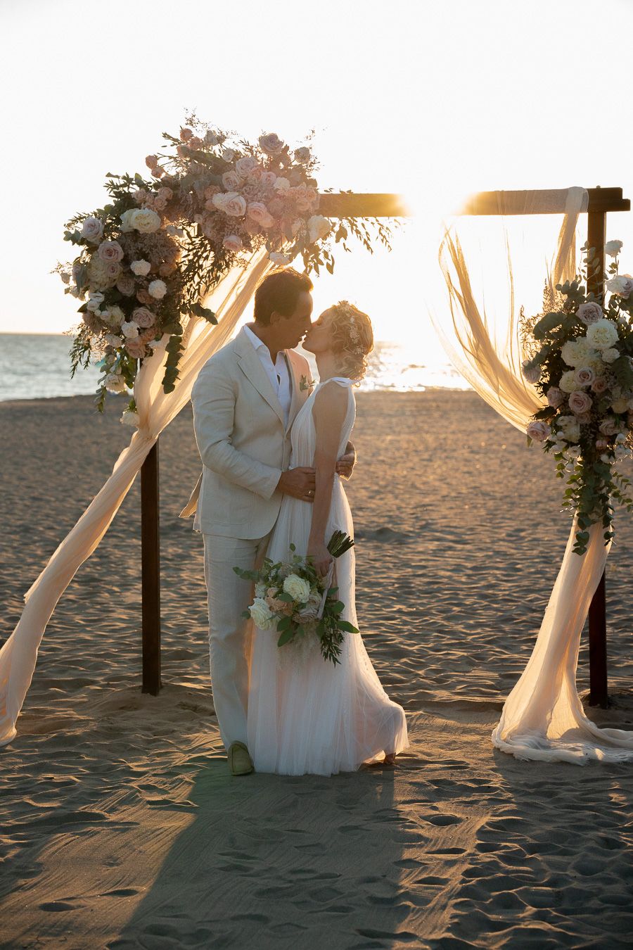 Seaside wedding ceremony in Tuscany at golden hour