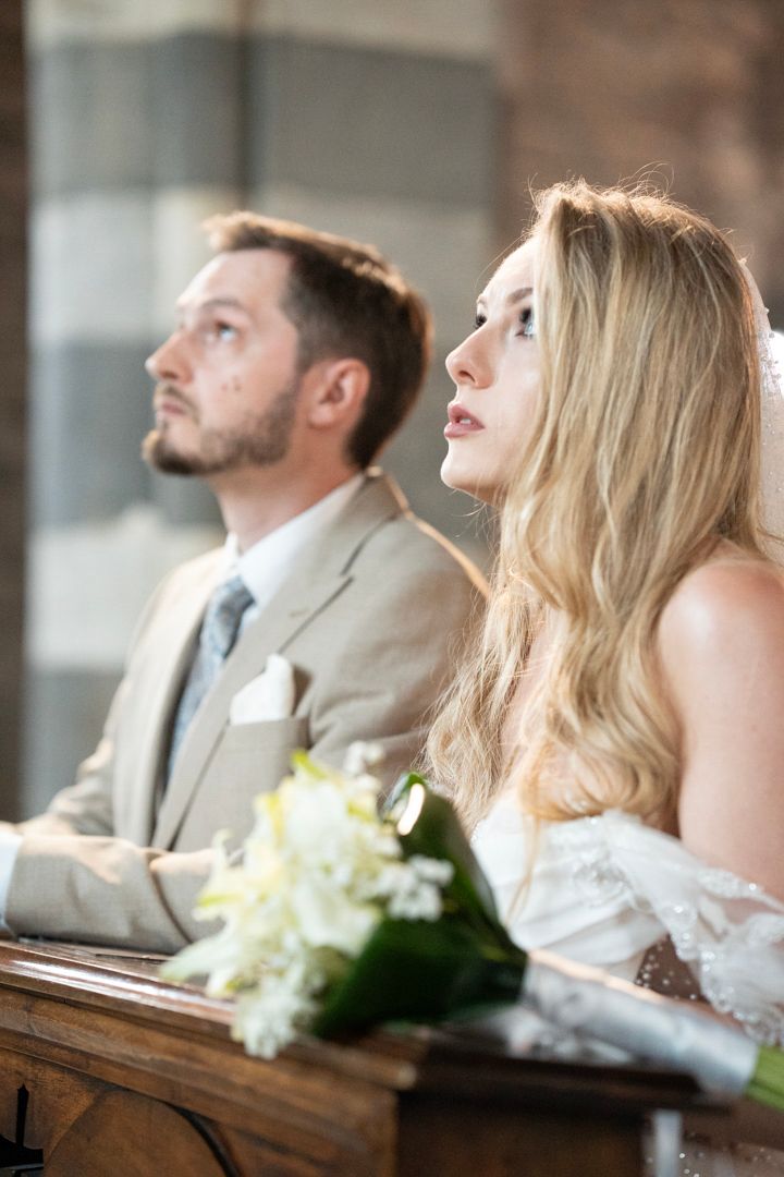 Wedding couple seated during the church ceremony