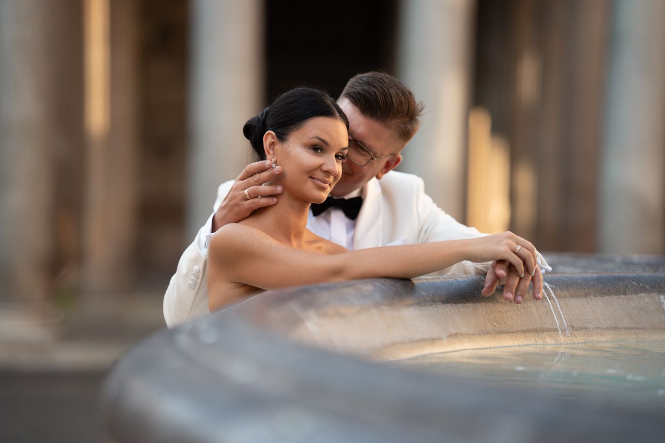 Wedding couple portrait by a historic fountain in Rome, Italy