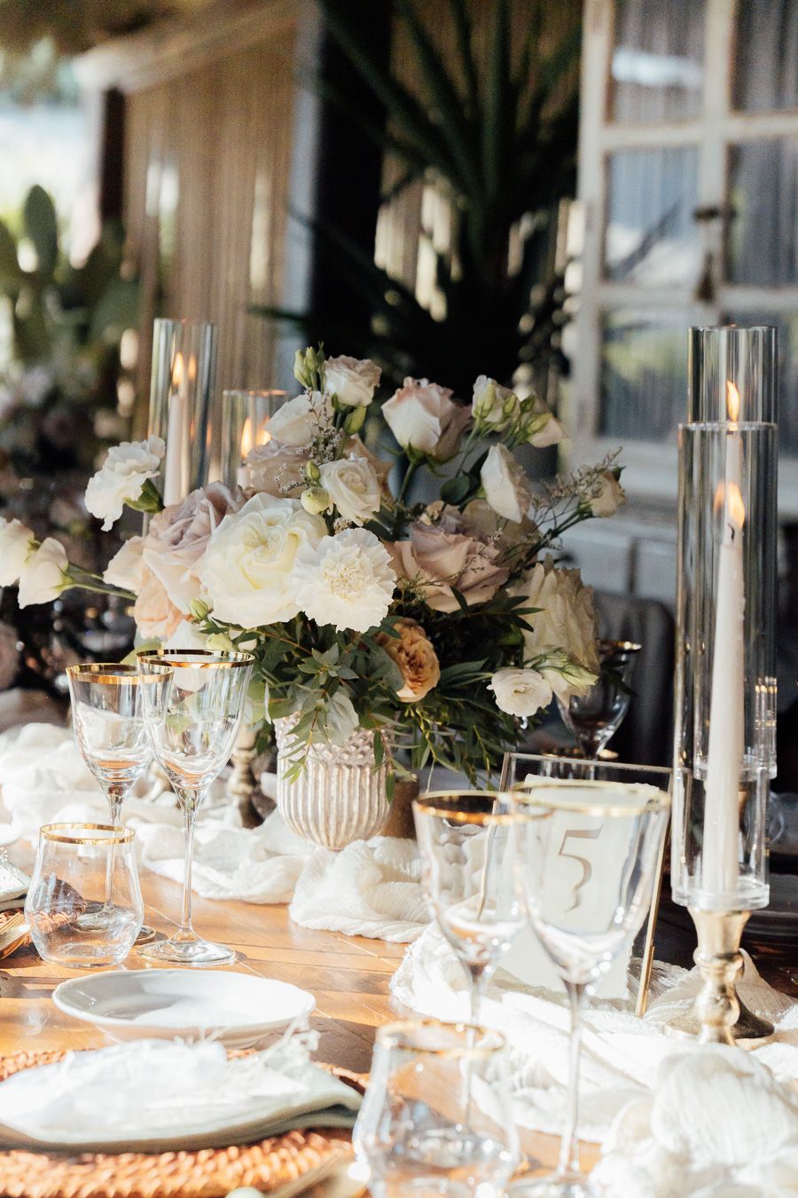 Elegant Tuscany wedding reception with white floral arrangements