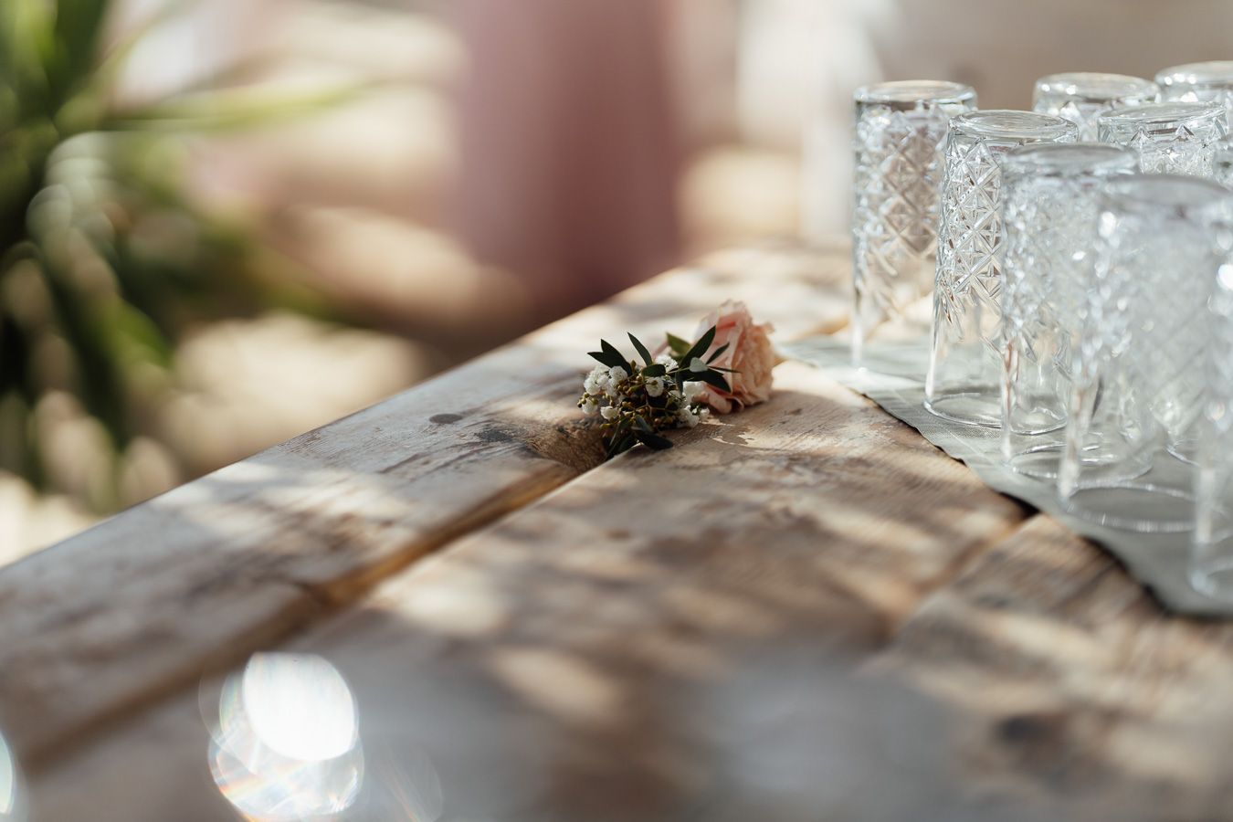 Wedding reception table with flowers and glassware in Tuscany