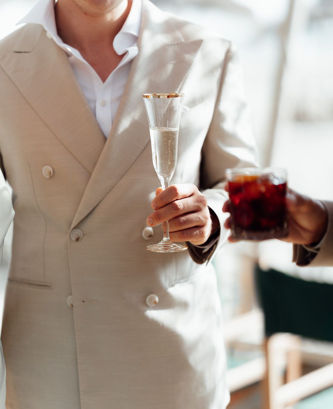 Wedding guest holding a champagne glass at a Tuscany wedding