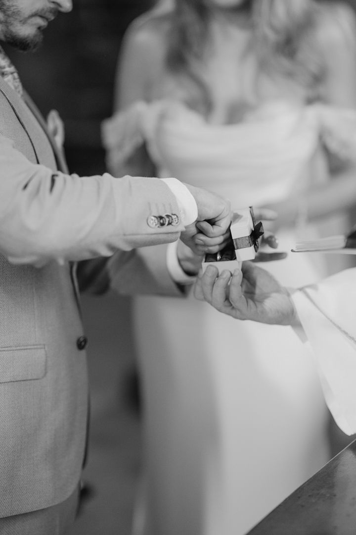 Black and white wedding ring exchange close-up