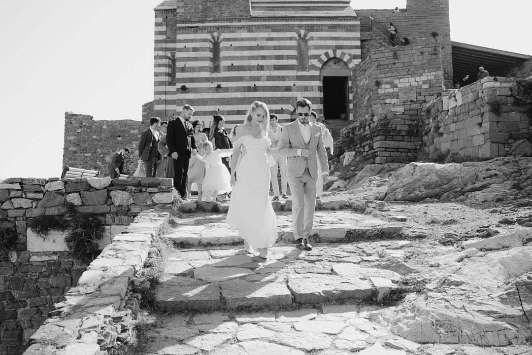Wedding guests walking through a historic Ligurian setting