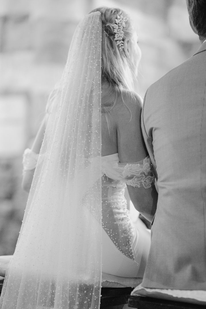 Black and white wedding ceremony detail with bridal veil
