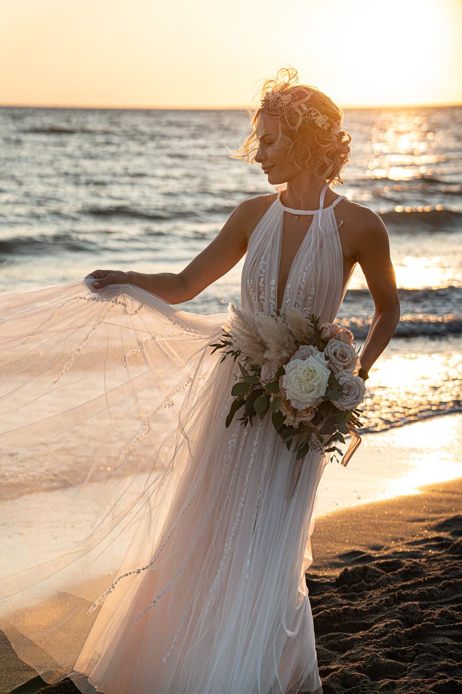Sunset wedding portrait on the beach in Tuscany, Italy