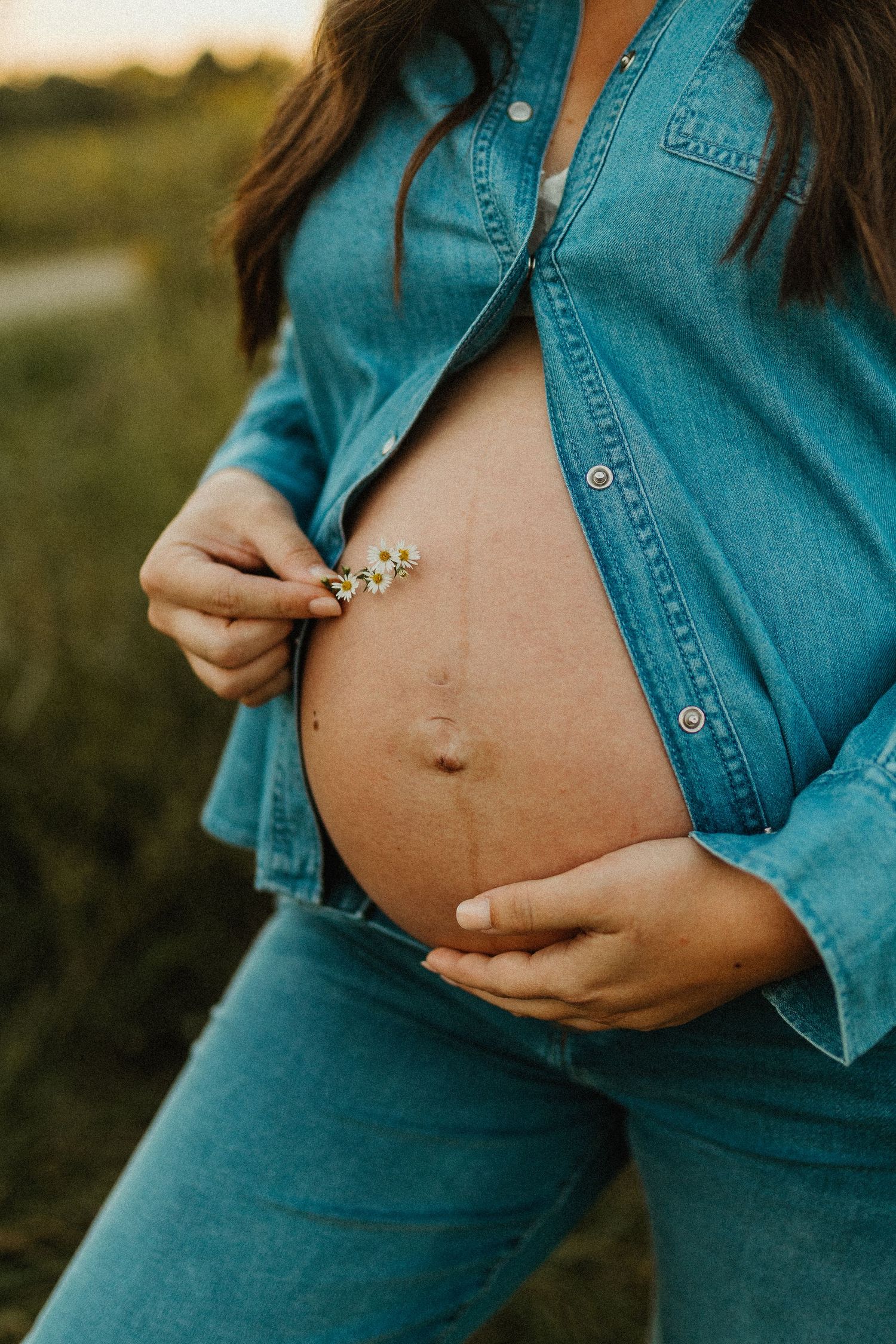 Close-up of pregnant belly with denim jacket showing progression of pregnancy growth in multiple photos.