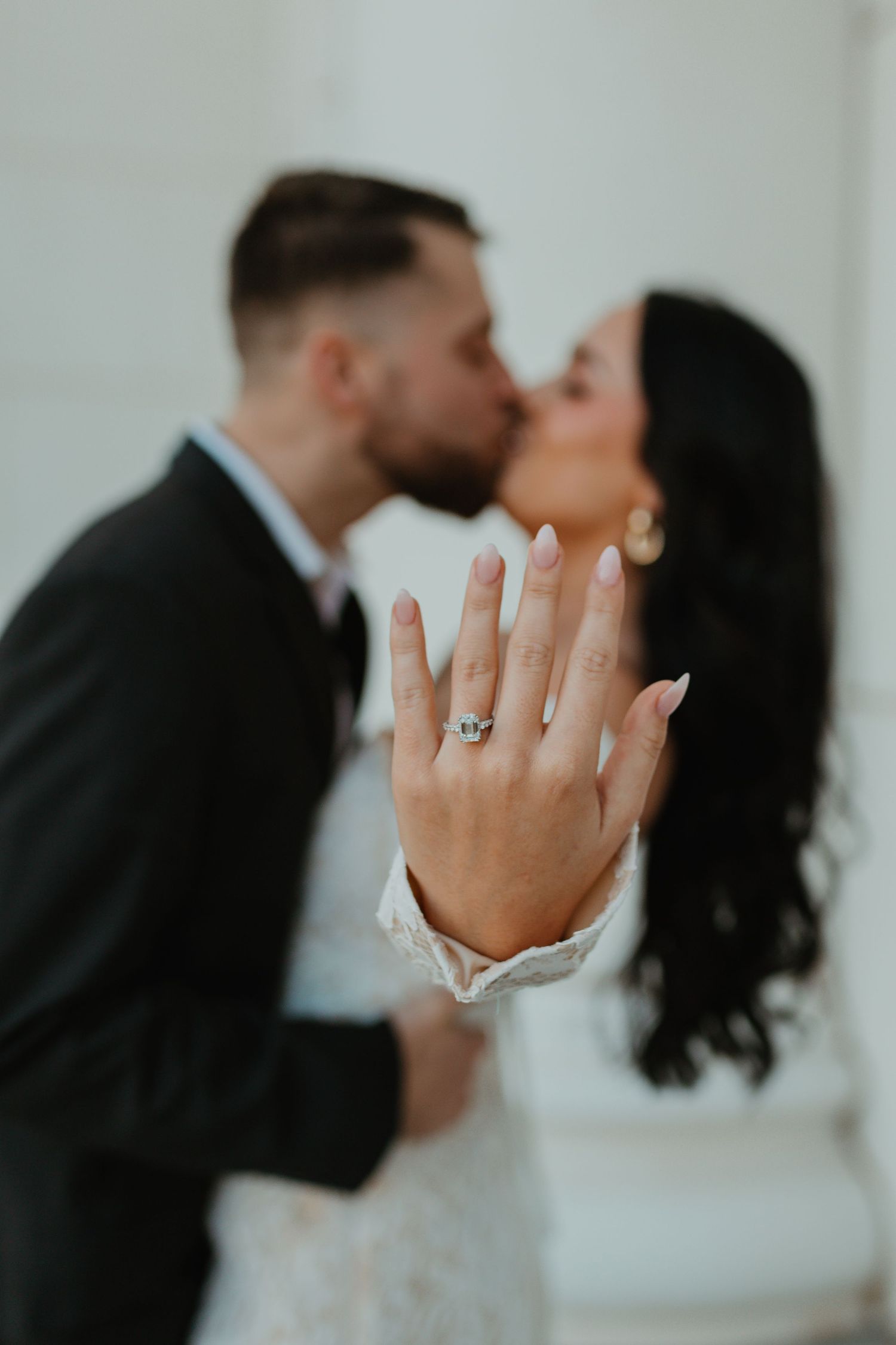A romantic series of engagement photos showing a couple kissing while displaying an engagement ring.