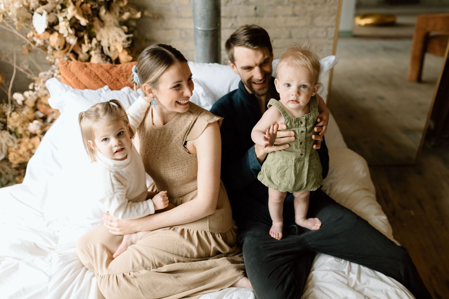 Intimate family lifestyle portraits taken in a rustic indoor setting.