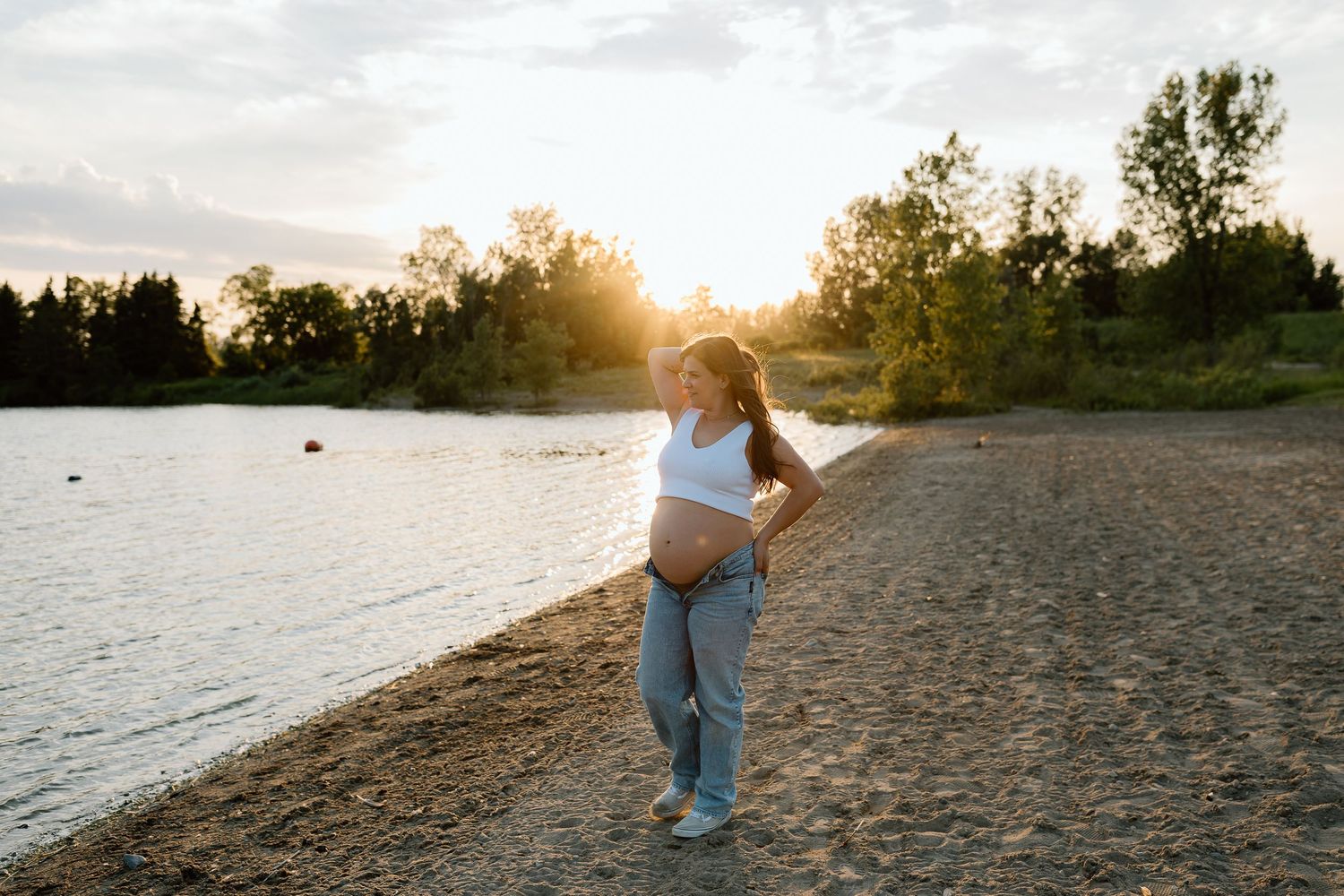 Maternity silhouettes photographed against a sunset beach landscape.