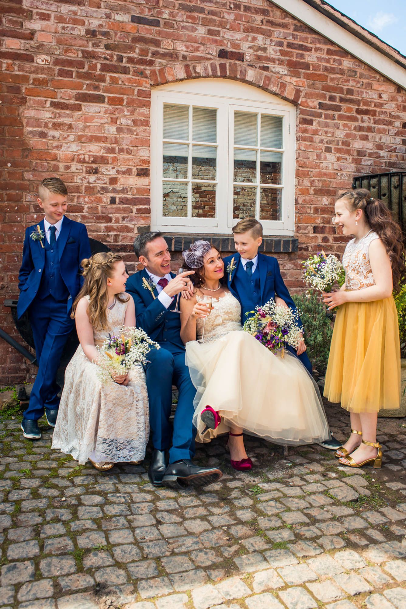 Nottingham wedding photographer capturing natural documentary moments of a wedding party poses together