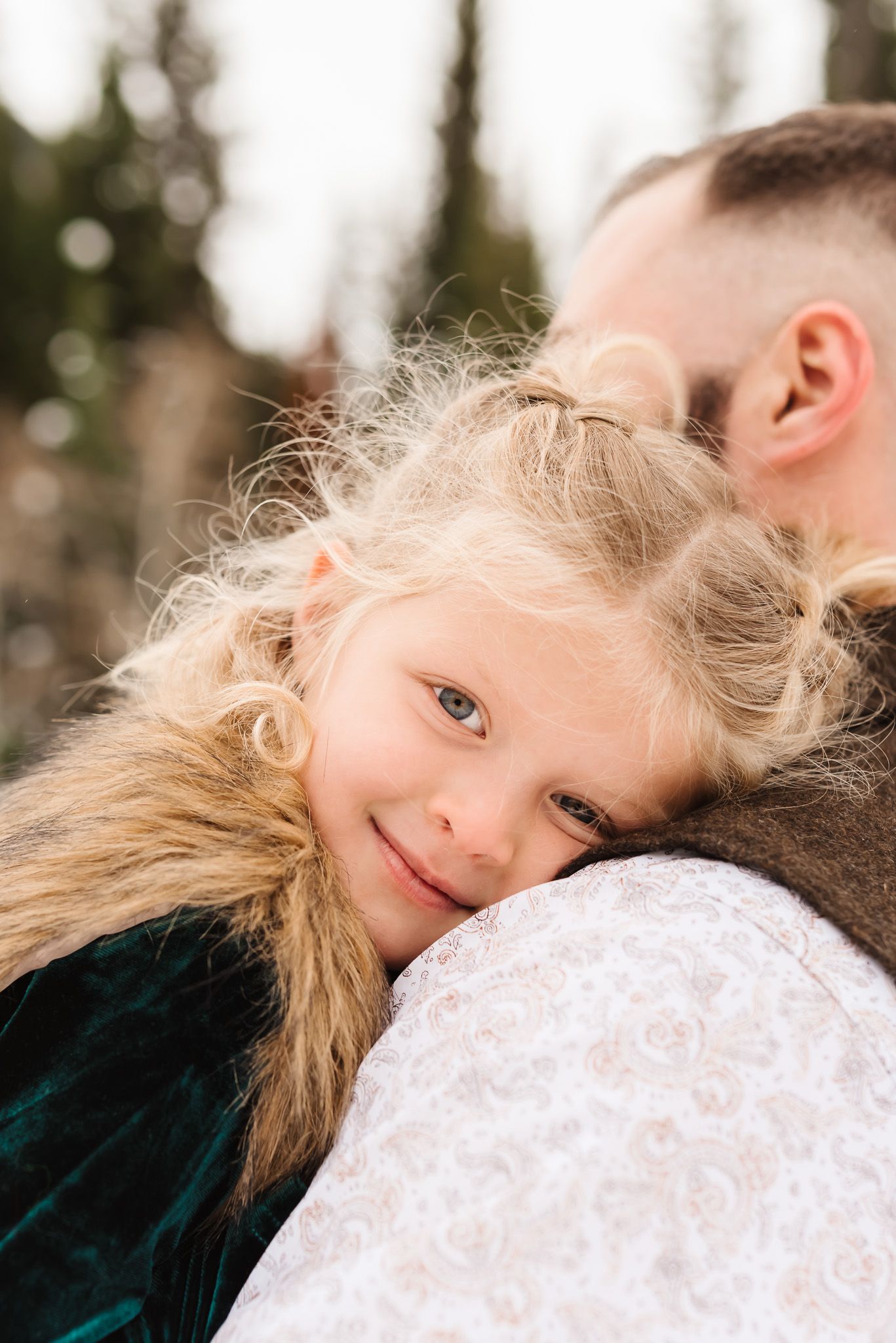 Close-up portrait shots showing intimate expressions against a snowy mountain backdrop.