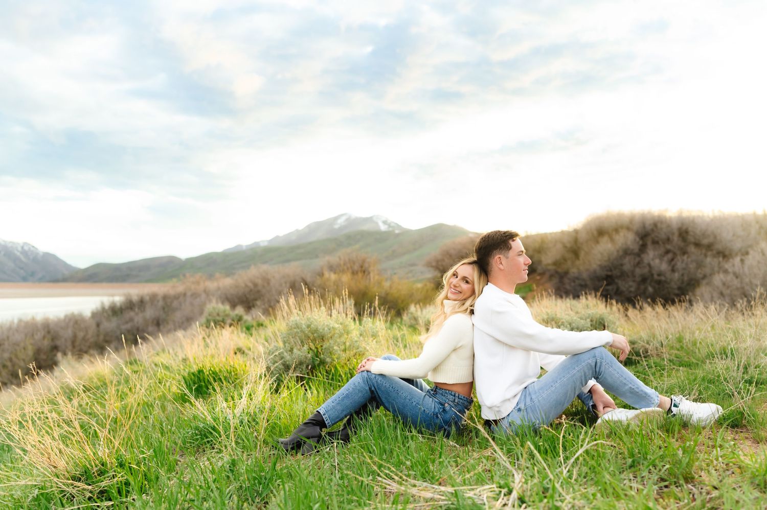 Relaxed outdoor portrait session in a mountain meadow during golden hour.