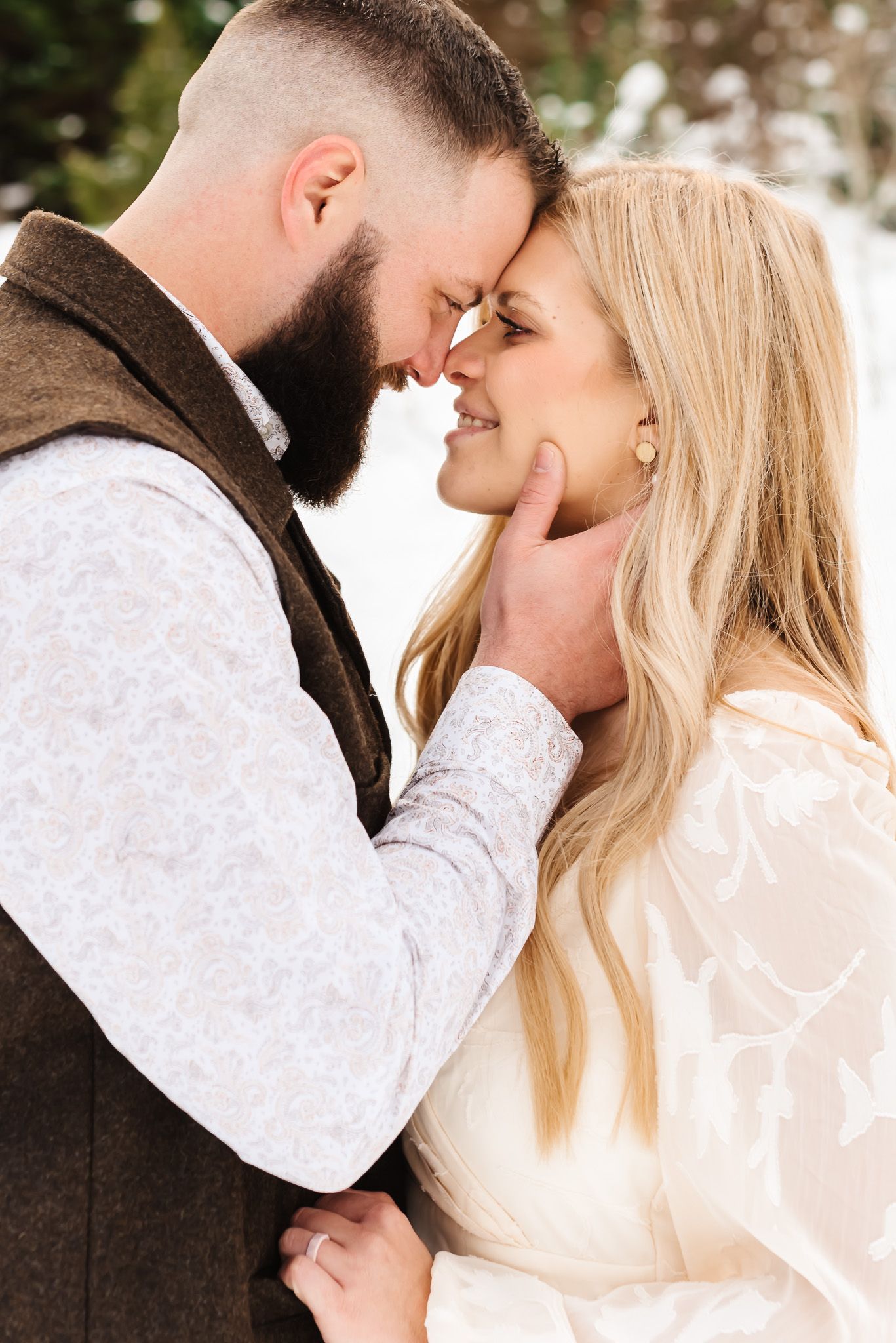 Intimate close-up portraits of couple sharing romantic moments in winter setting.