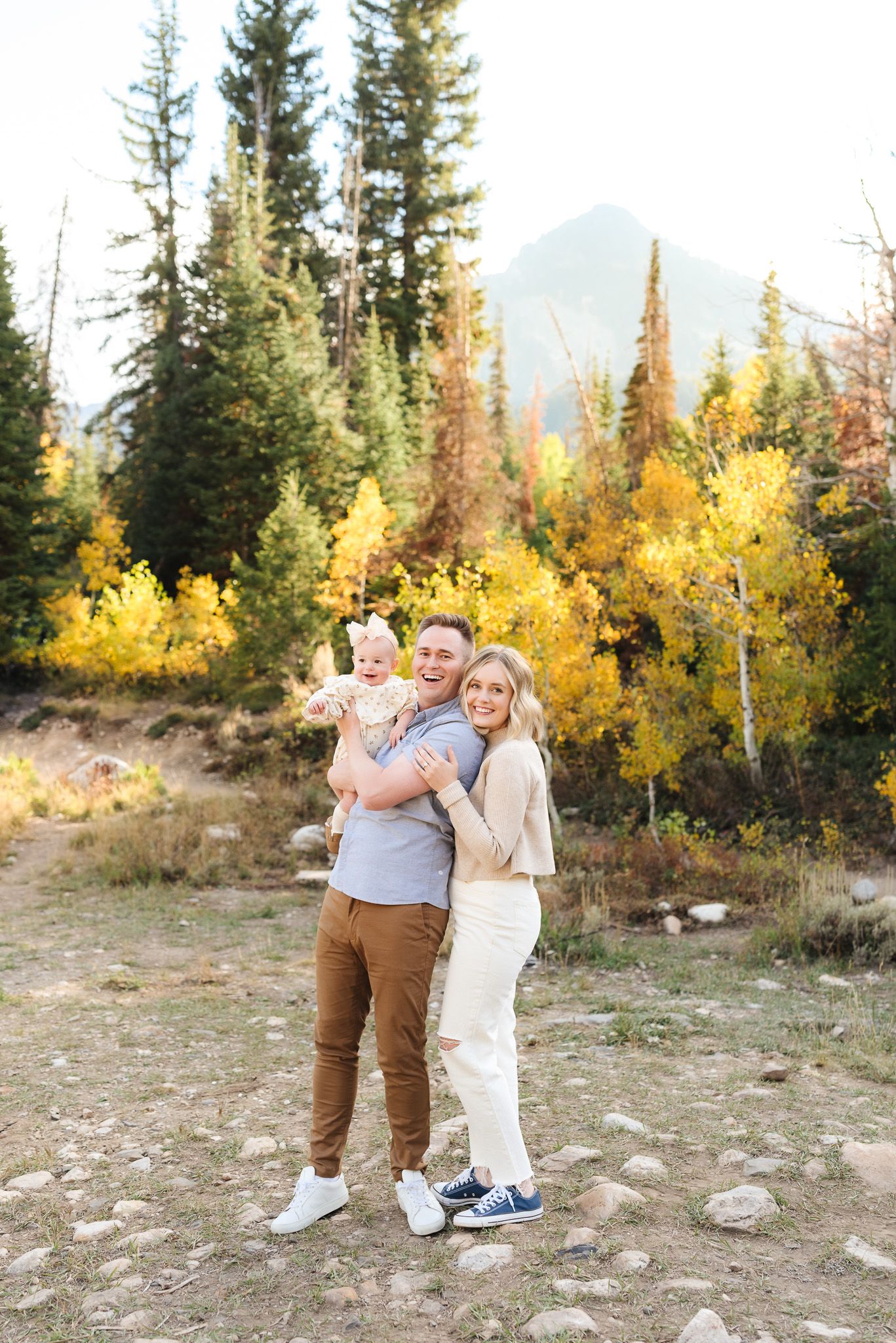 Family enjoying outdoor moments together against beautiful fall mountain scenery.