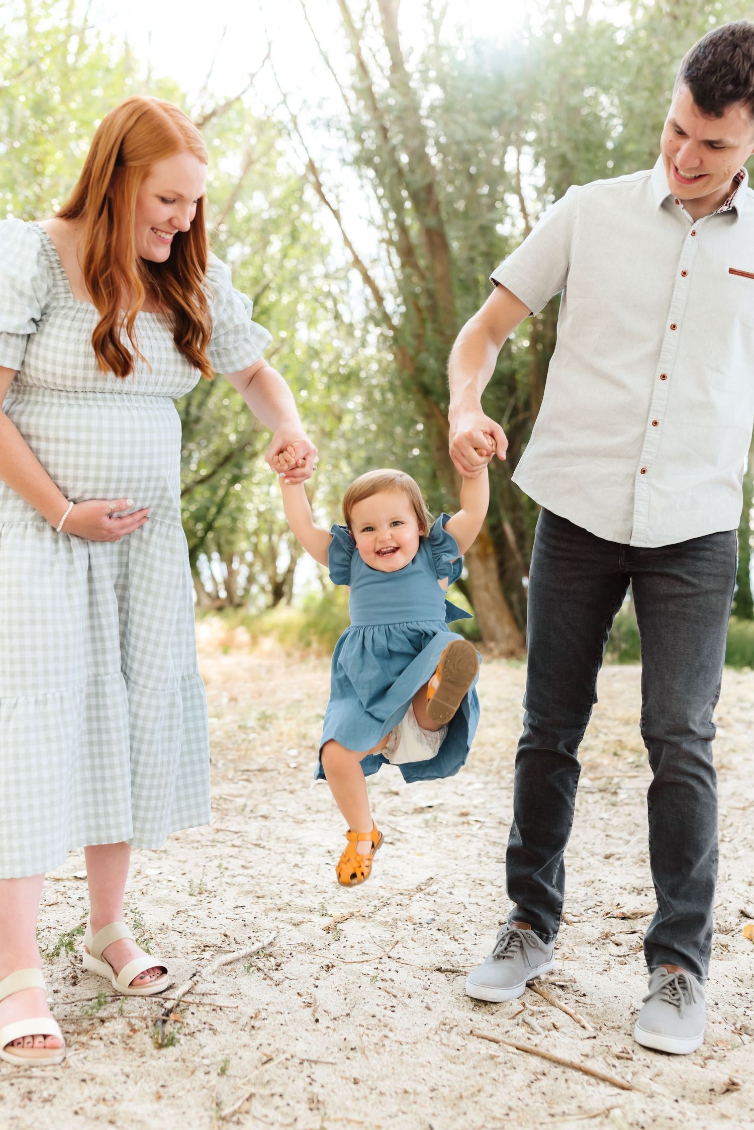 Candid family moments captured during a fun outdoor photoshoot on a sunny day.