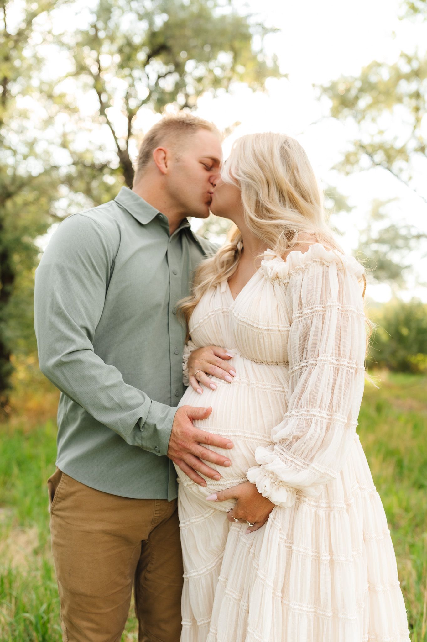 Romantic couple portraits in a natural setting wearing coordinated neutral colors.