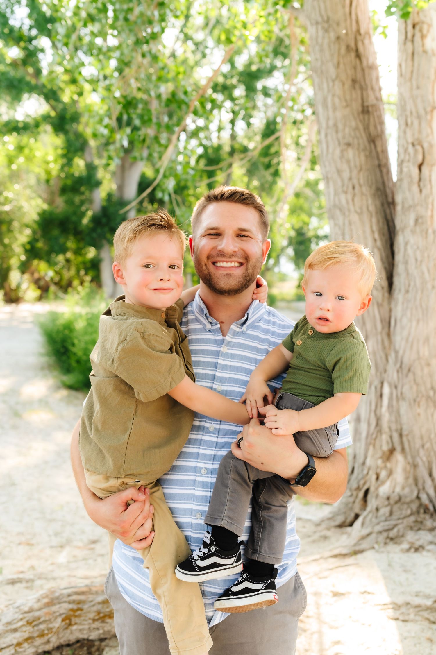 Candid outdoor family photos showing playful moments between parent and children.