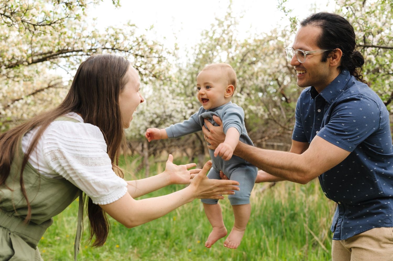 A series of candid family photos showing playful moments between parent and baby in a sunny outdoor setting.