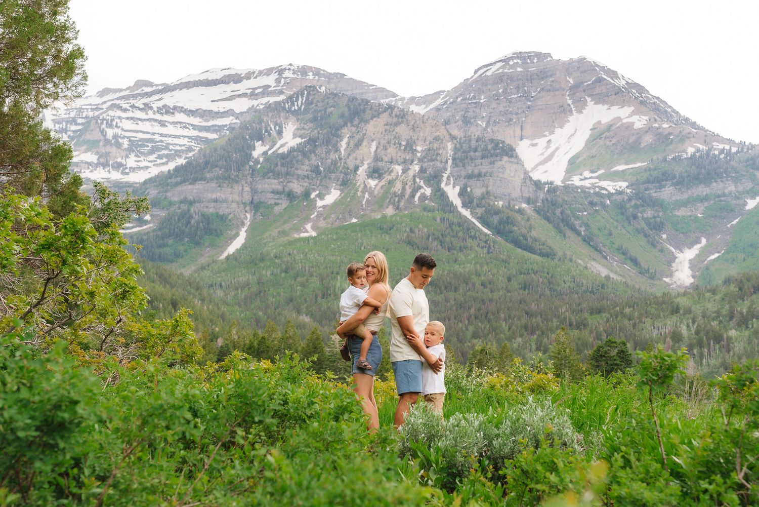 Beautiful mountain landscape serves as backdrop for family photos in nature.
