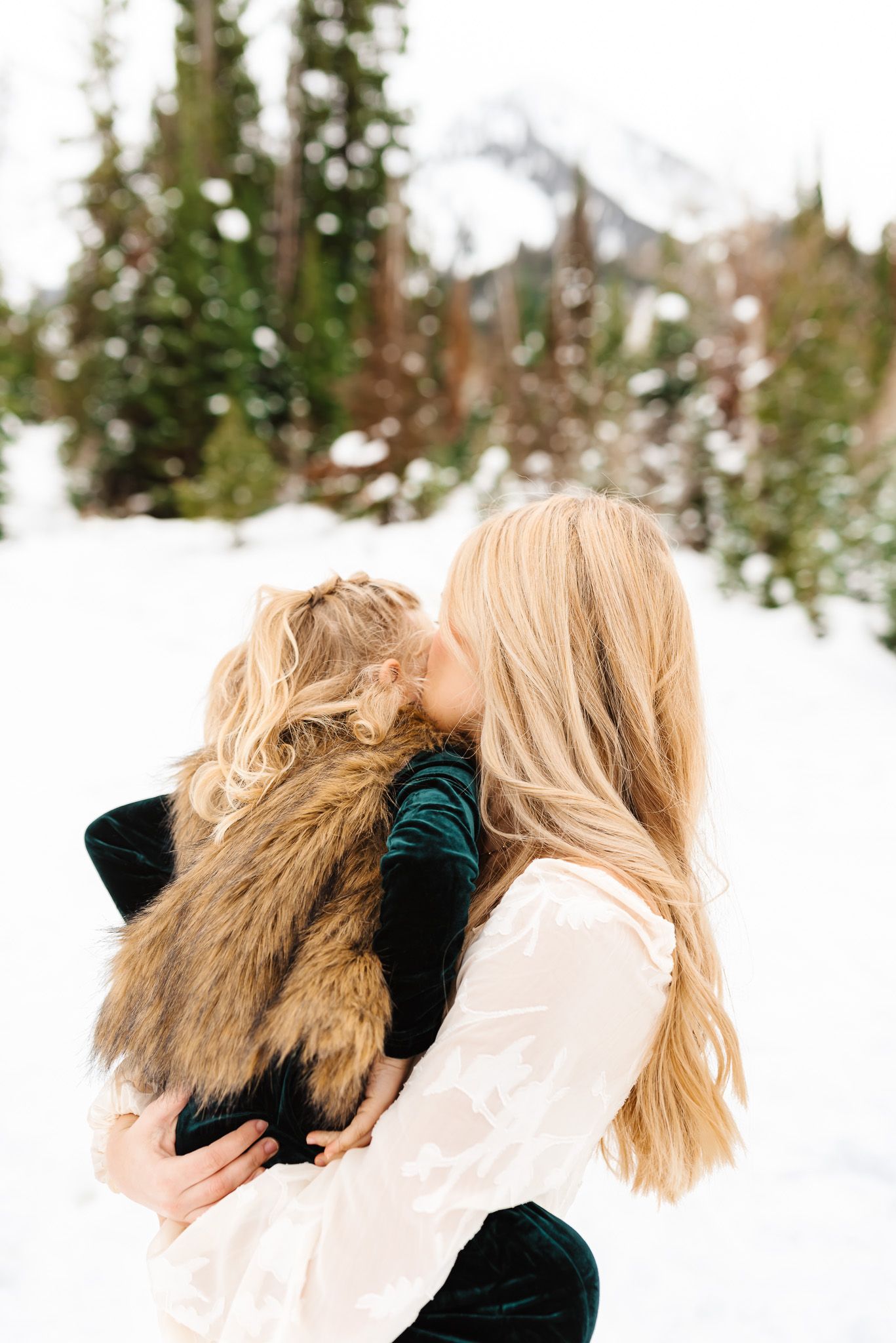 Candid family expressions captured during a winter photo session in the snow.