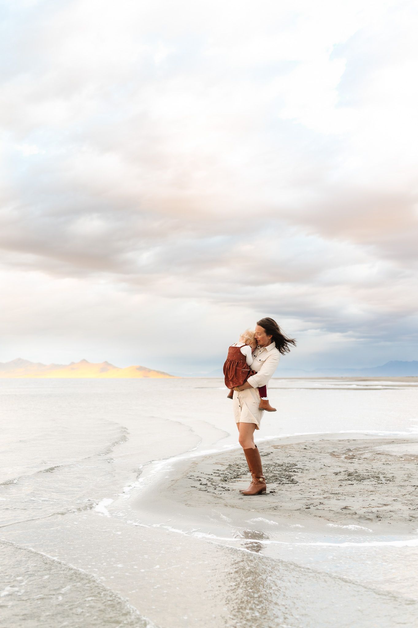 Mother and daughter standing on the salt lake shore at Saltair