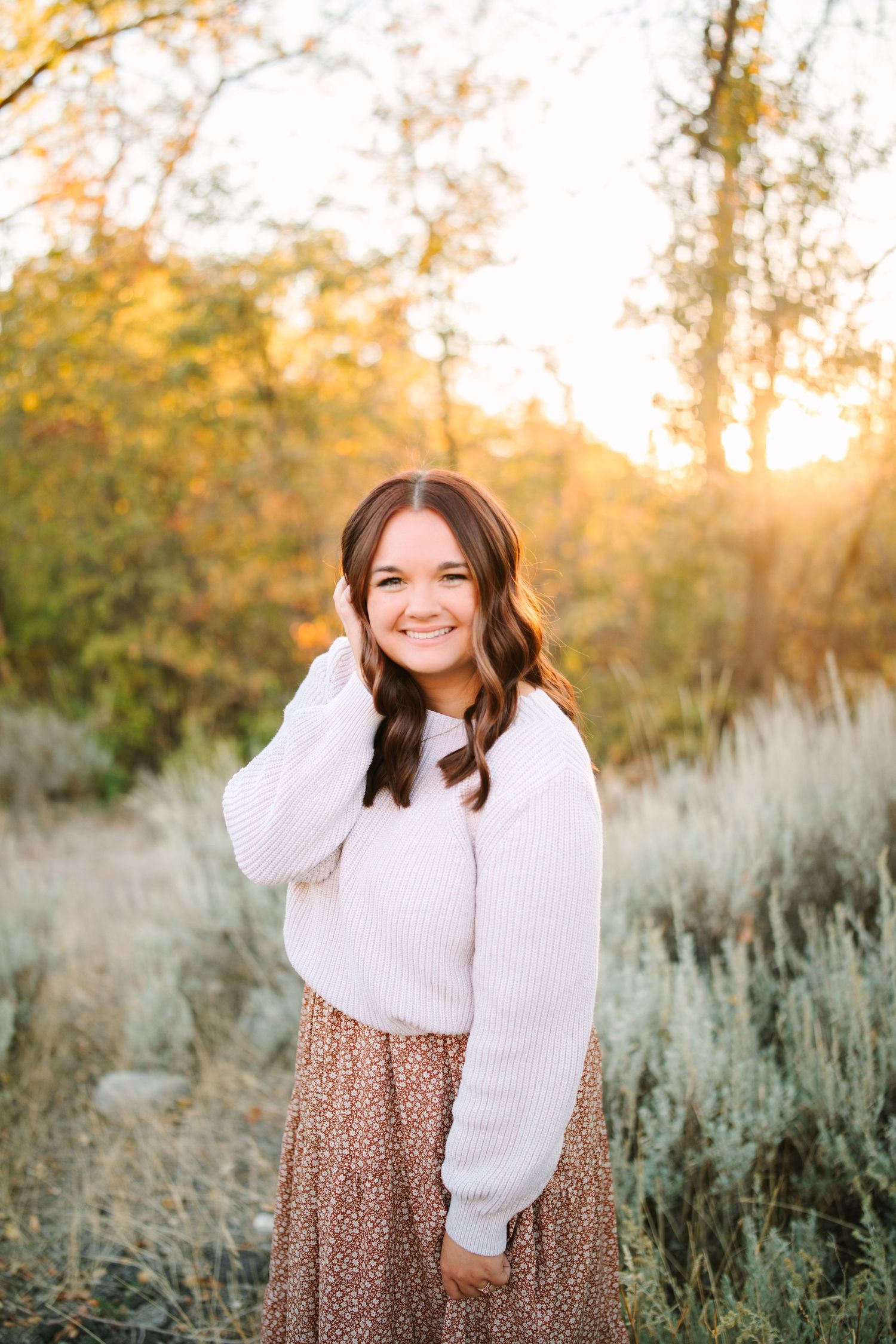 A series of outdoor portrait photos taken in golden sunlight with desert sage brush and autumn trees in the background.