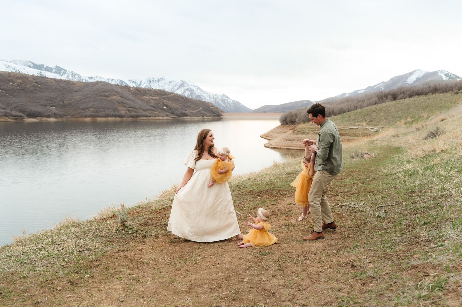 Scenic mountain engagement photos with snow-capped peaks and lake in the background.