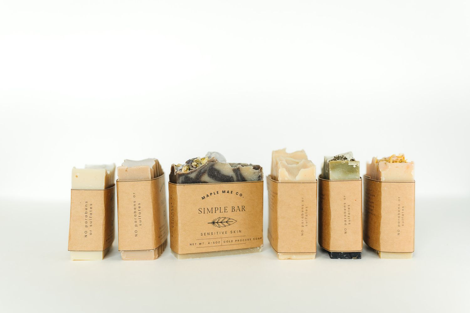 A row of vintage brown paper coffee bags arranged in a line against a white background.