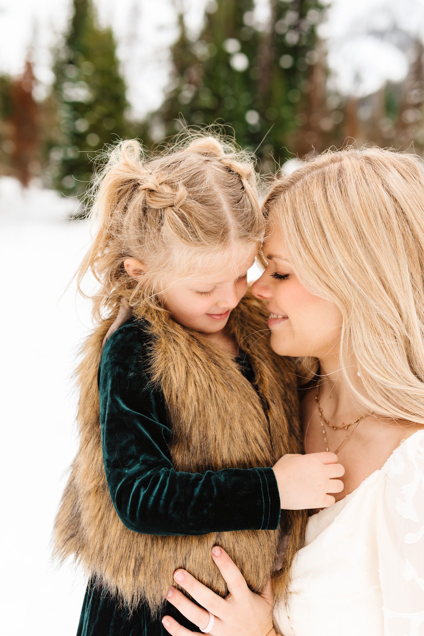Intimate family portraits showing loving interactions in a snow-covered mountain setting.