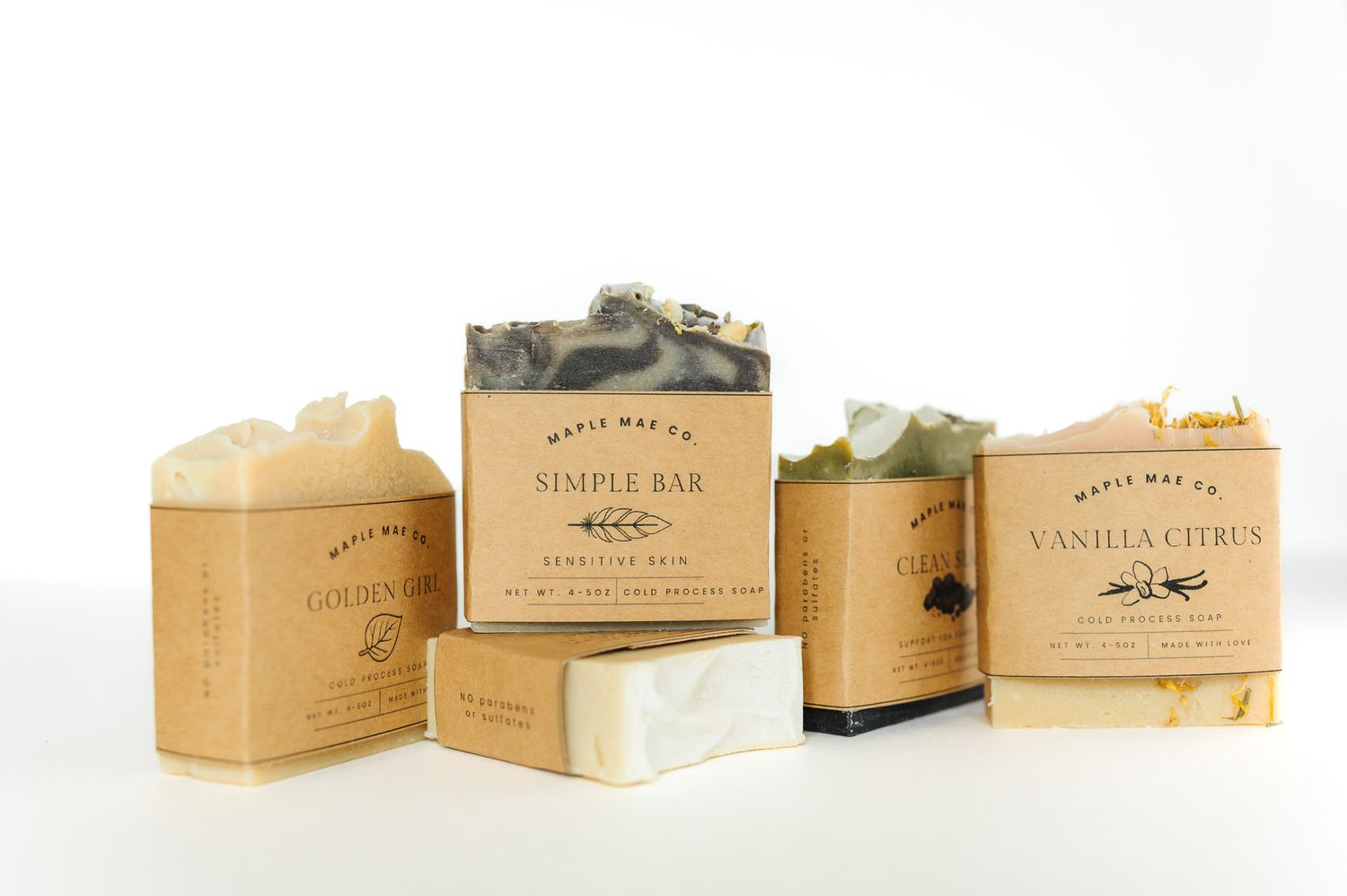 Maple Mae Co artisan soap bars including Simple Bar and Vanilla Citrus varieties displayed on kraft paper packaging.