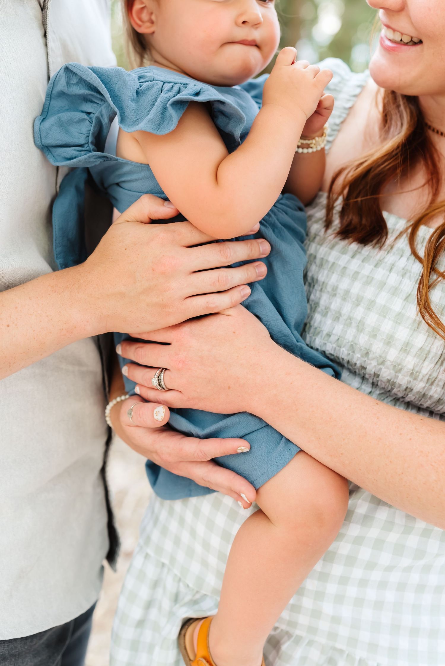 Close-up shots of tender family moments in a casual outdoor setting.