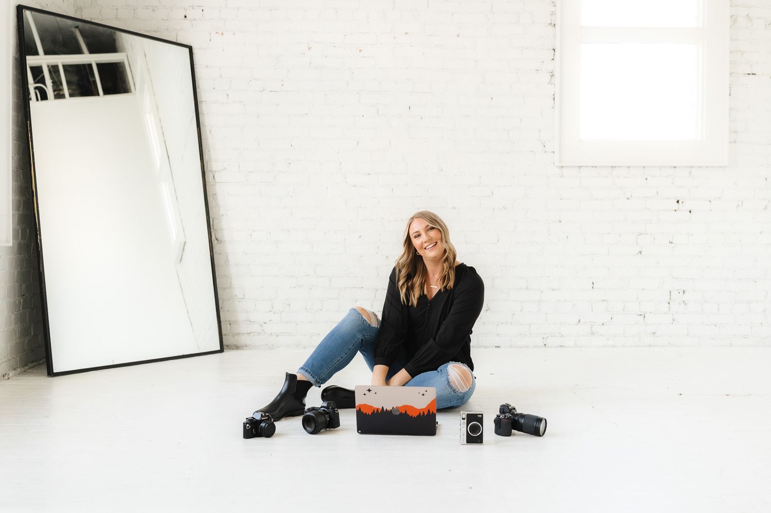 Minimalist white studio space with artistic portrait compositions and natural lighting.