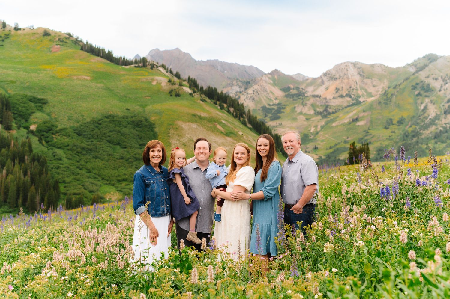 Group photo session in a wildflower-filled mountain meadow during summer.