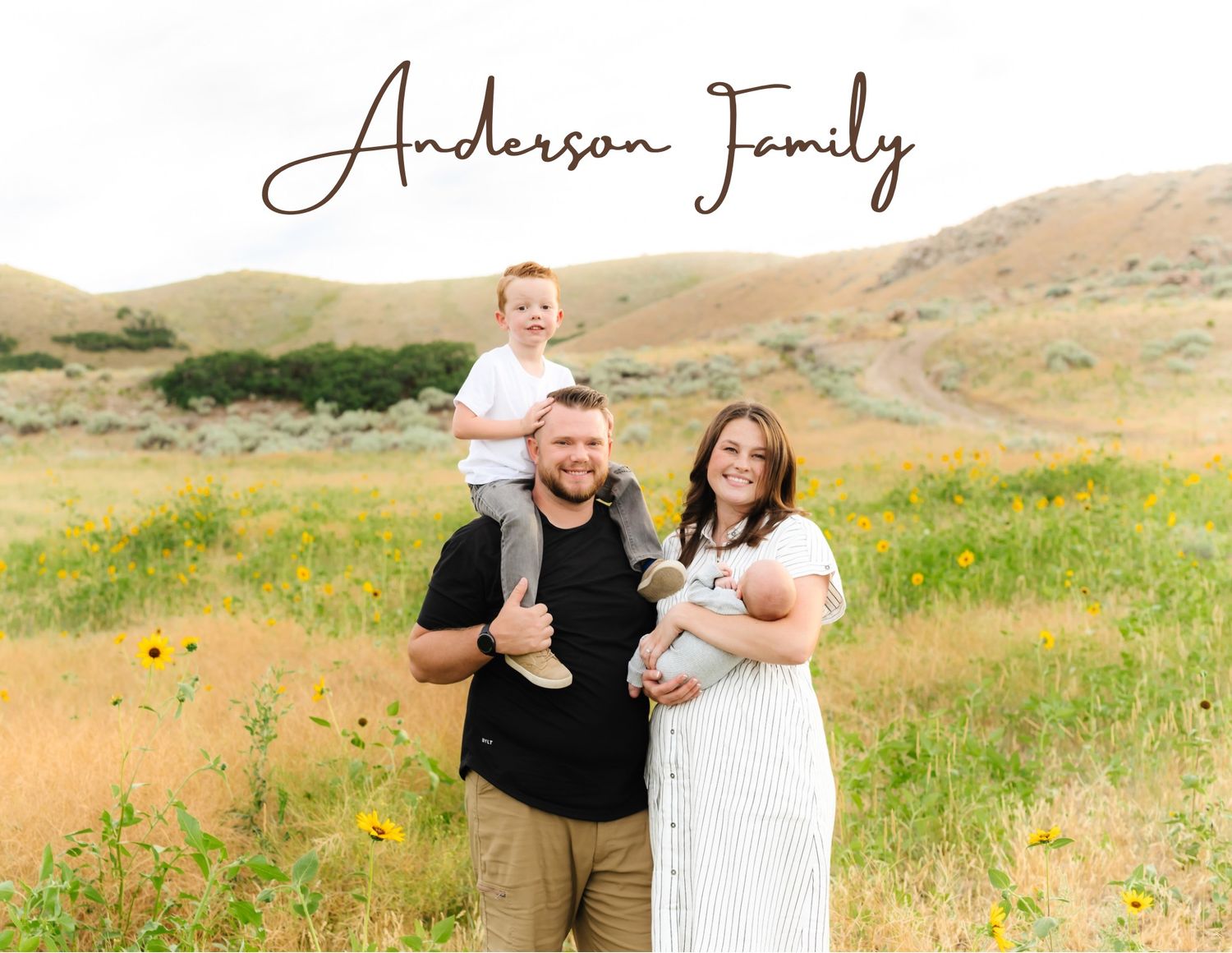 Family portrait session in wildflower field with rolling hills backdrop.