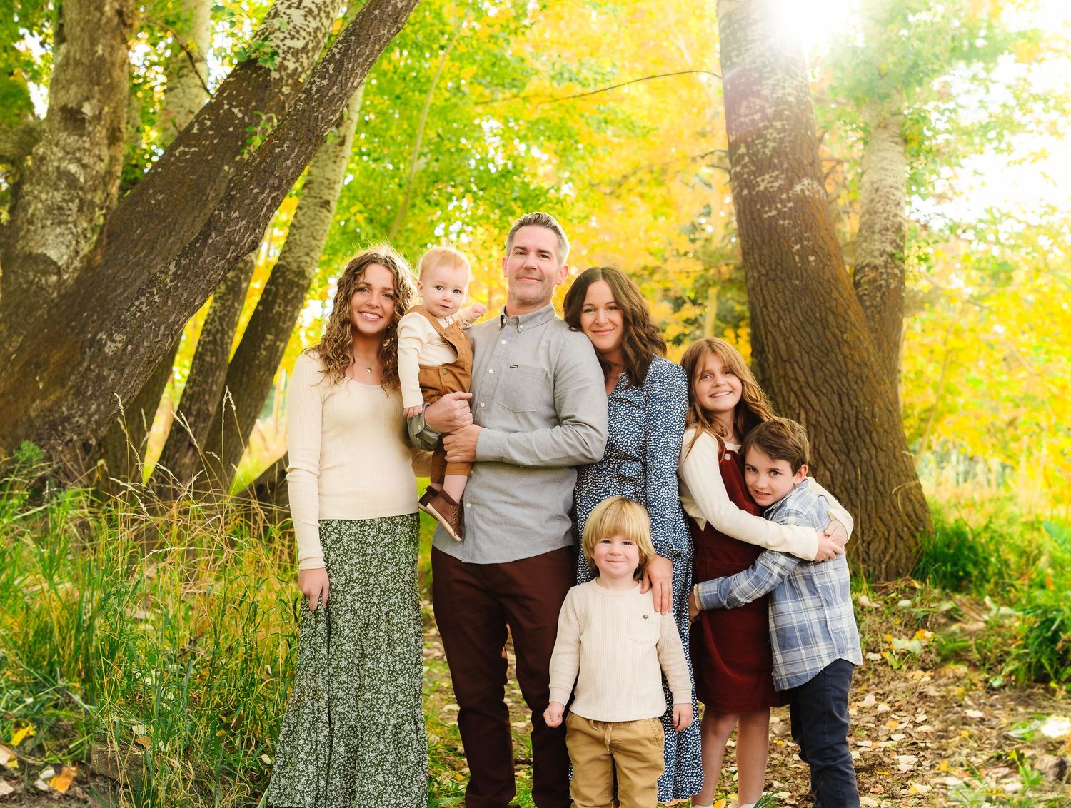 Series of candid family interactions captured against a backdrop of golden fall trees.