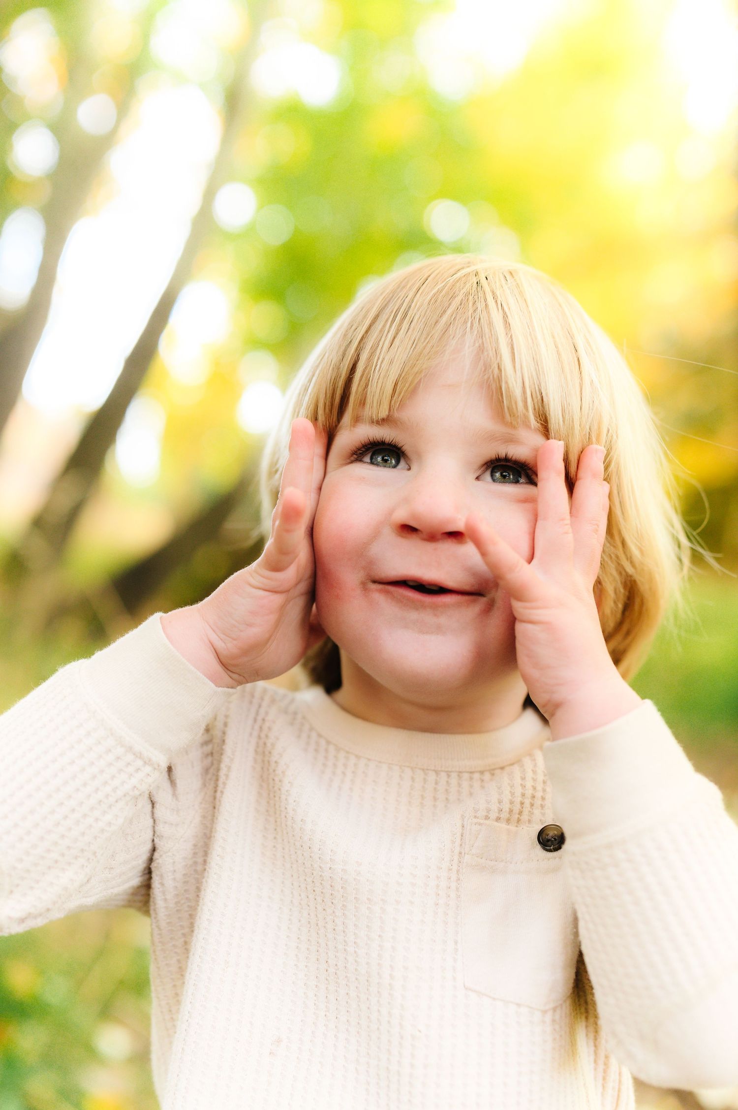 Playful sequence of expressions captured in a cream sweater against a bright natural backdrop.