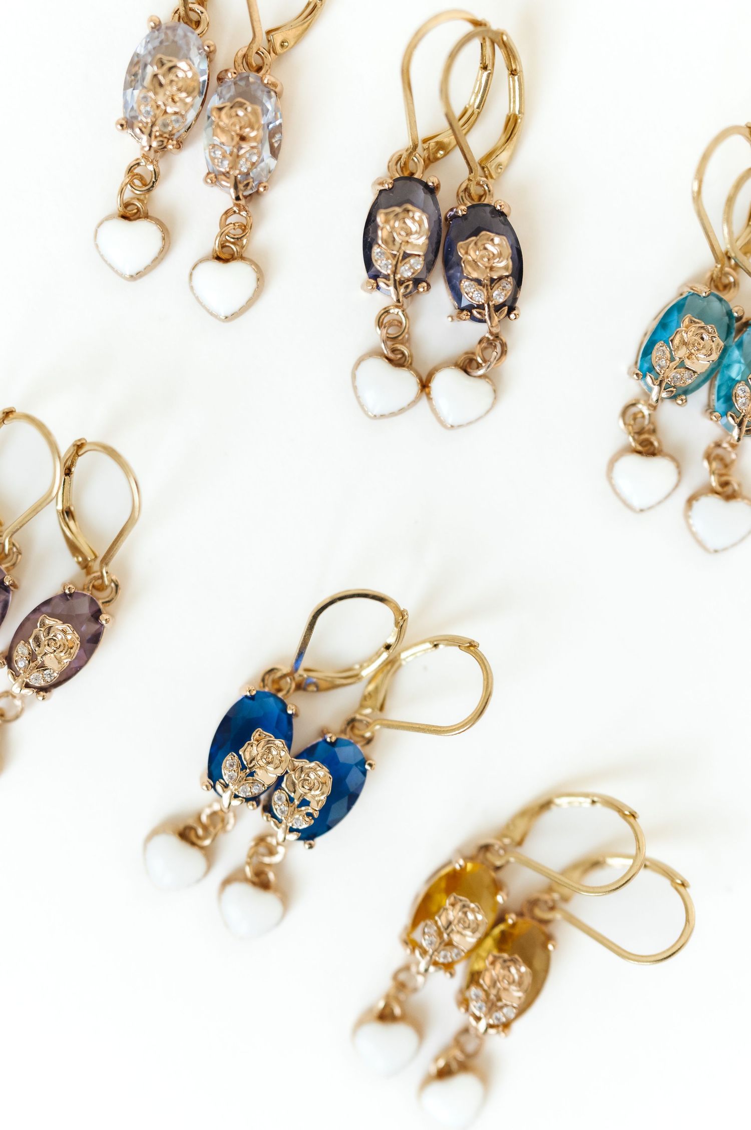 Assortment of vintage-style earrings with pearls and blue enamel details.