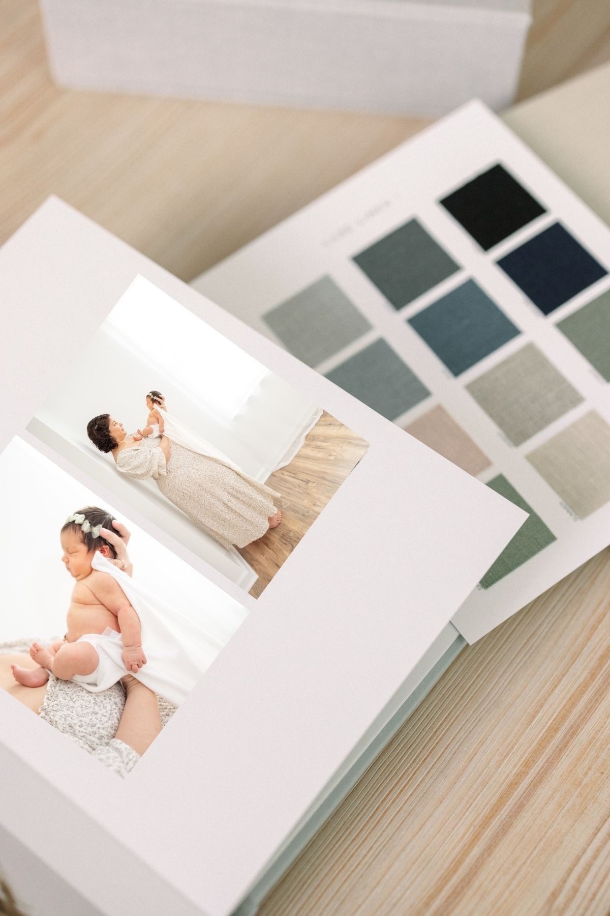 Photo album displaying color swatches and photographs alongside paint or fabric samples in muted tones.